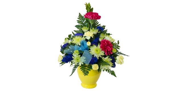 Red, yellow and blue flowers in yellow vase