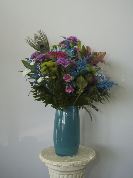 Teal Vase with teal and purple flowers